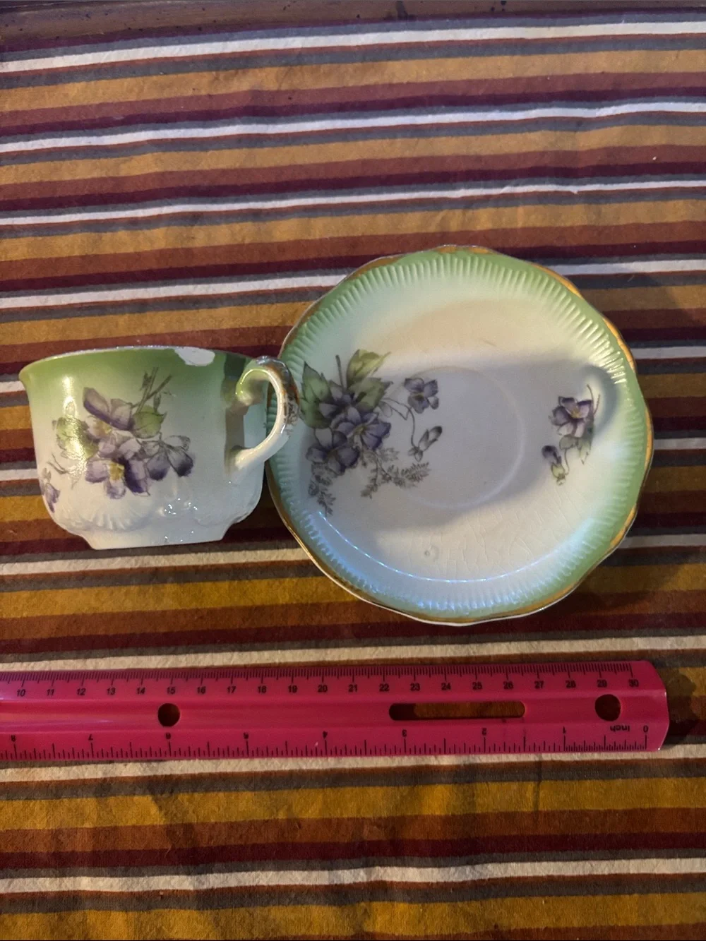 Green Porcelain Teacup and Saucer with Purple Floral Accents